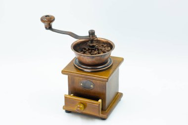 hand coffee grinder with coffee beans on white background