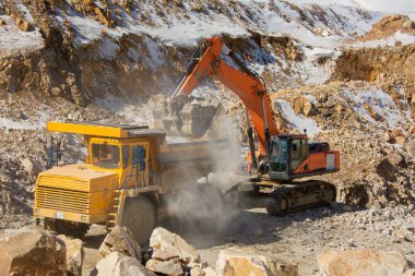 Quarry extraction of silicon. Minerals. Loading and transportation of minerals. Truck and excavator