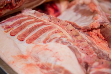 cooking pork sausages concept of sausage and delicatessen productionA slaughterhouse worker cuts chunks of meat into portions. A concept of sausage and delicatessen production.