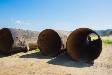 large rusty metal waste water pipes