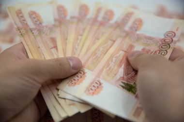 Russian rouble. five thousand rubles. Money in hand. Fan of mone