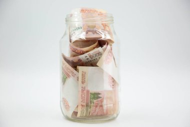 Russian rouble. the money is in a glass jar. five thousand ruble