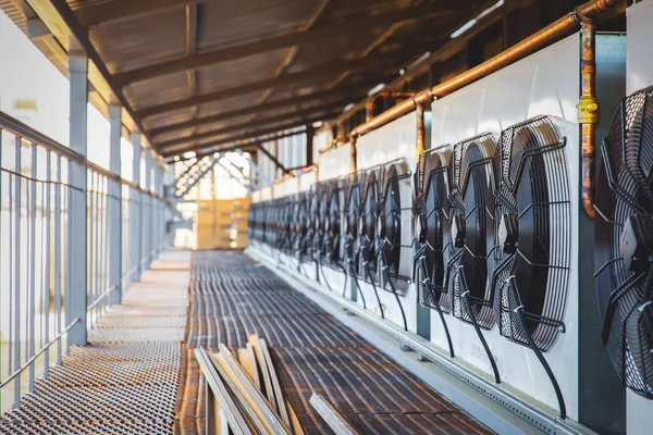 The ventilation system of a shopping center industrial air conditioner of large capacity. The air conditioning system is assembled on the side of the building.