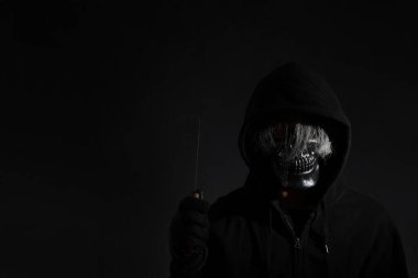 Karanlıkta duran kafatası maskeli korkunç adam..