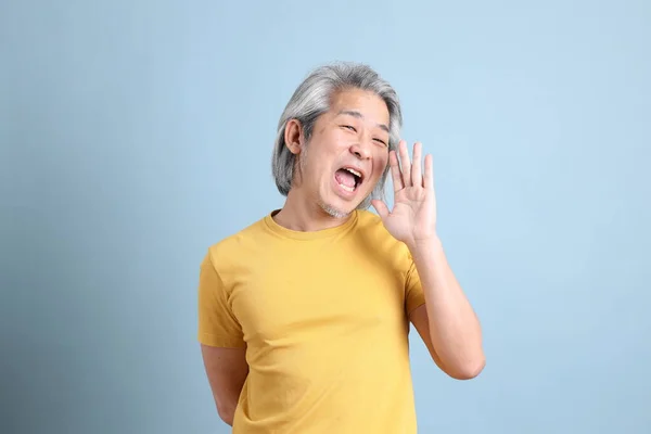 Senior Asian Man Yellow Shirt Standing Blue Background — Stock Photo, Image