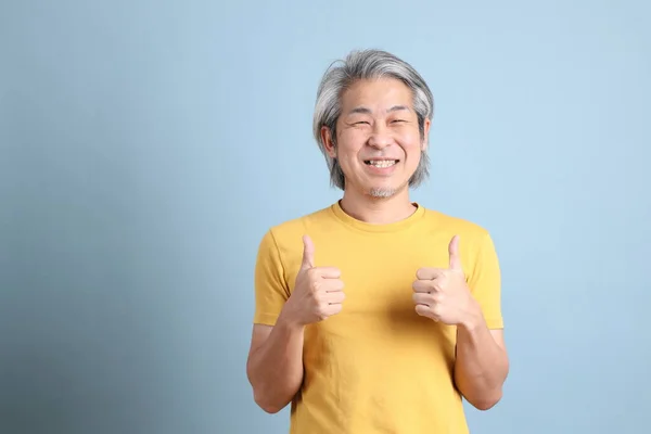 Senior Asian Man Yellow Shirt Standing Blue Background — Photo
