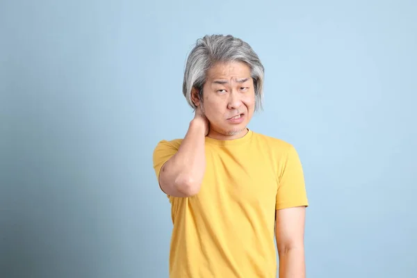 Senior Asian Man Yellow Shirt Standing Blue Background — Foto Stock