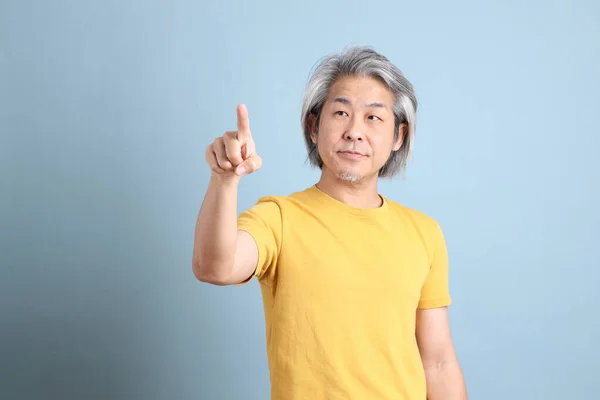 Senior Asian Man Yellow Shirt Standing Blue Background — 스톡 사진