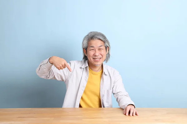 Senior Asian Man Grey Shirt Sitting Working Desk Blue Background — Photo