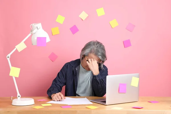 Senior Asian Man Sitting Working Desk Lot Paper Work Pink — Fotografia de Stock