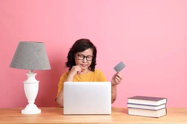 Senior Asian Woman Working Laptop Sitting Desk Pink Background — Photo