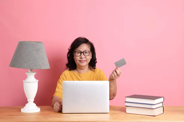 Senior Asian Woman Working Laptop Sitting Desk Pink Background — Photo