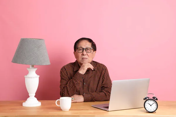 Senior Asian Man Sitting Working Desk Laptop Pink Background — Stockfoto