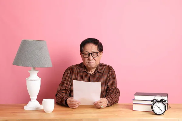 Senior Asian Man Sitting Working Desk Pink Background — Stockfoto