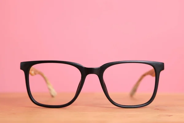Picture Glasses Wooden Desk Color Background — Stock Photo, Image