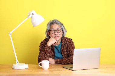 Dizüstü bilgisayarında çalışan renkli bir Asyalı..