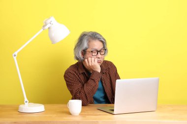 Dizüstü bilgisayarında çalışan renkli bir Asyalı..