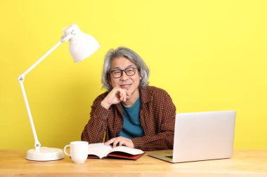 Dizüstü bilgisayarında çalışan renkli bir Asyalı..