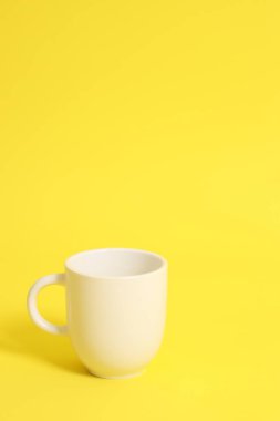 Beyaz kahve fincanı kırmızı arka planda duruyor..