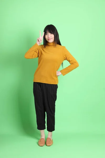 Мила Дівчина Азії Одягнена Недбало Стоїть Зеленому Тлі — стокове фото