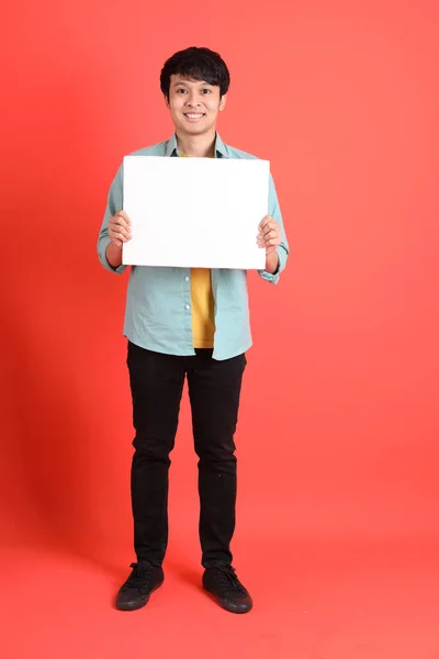 Young Adult Southeast Asian Man Green Shirt Standing Orange Background — Stock Photo, Image