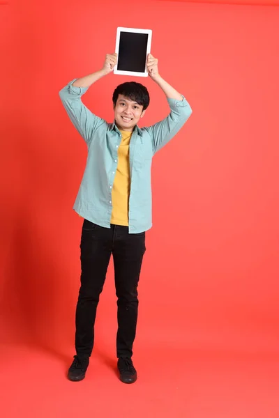 Young Adult Southeast Asian Man Green Shirt Standing Orange Background — Stock Photo, Image