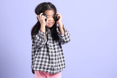 Mor arka planda duran genç Asyalı ızgara..