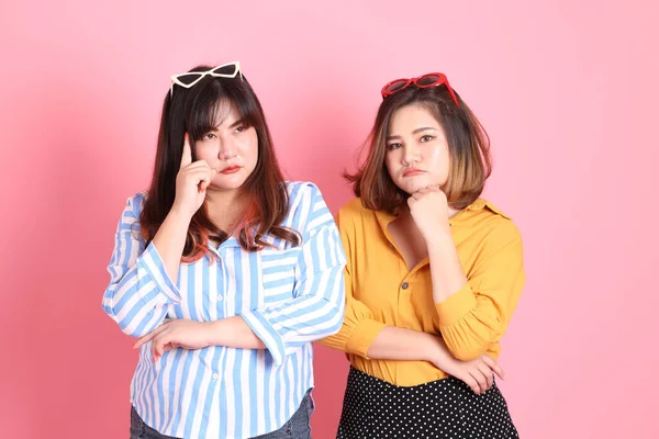 Pembe arka planda duran Asyalı mutlu kardeş..