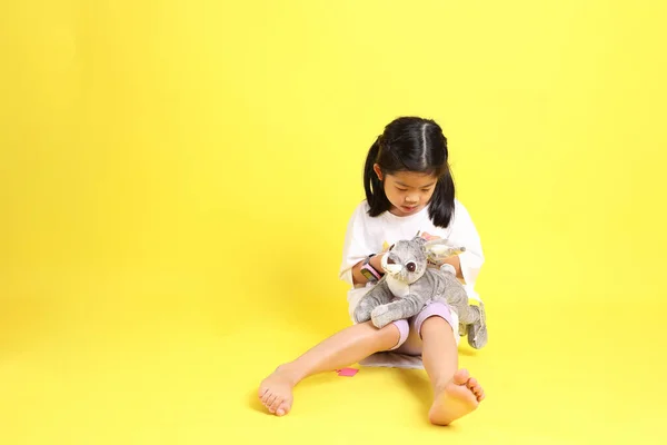 Little Asian Girl Casual Clothes Playing Yellow Background — Fotografia de Stock