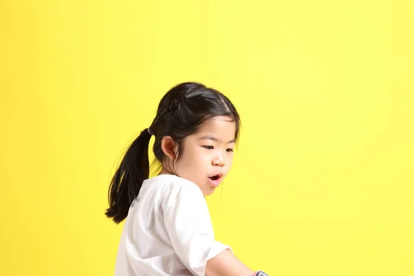 Little Asian Girl Casual Clothes Playing Yellow Background — Fotografia de Stock