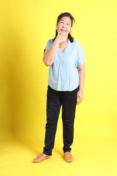 Asian Senior Woman Wearing Light Blue Shirt Standing Yellow Background — 스톡 사진