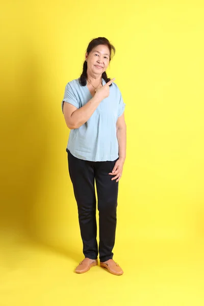 Asian Senior Woman Wearing Light Blue Shirt Standing Yellow Background — Photo