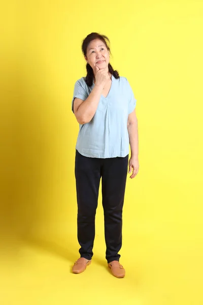 Asian Senior Woman Wearing Light Blue Shirt Standing Yellow Background — Photo