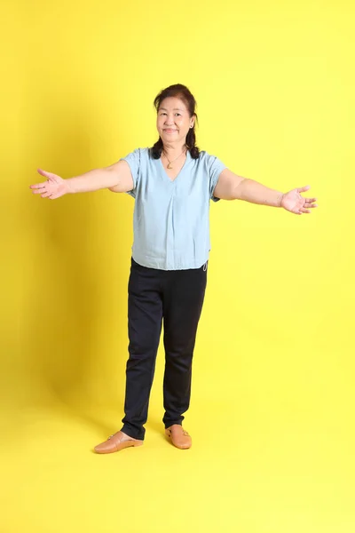 Asian Senior Woman Wearing Light Blue Shirt Standing Yellow Background — Photo