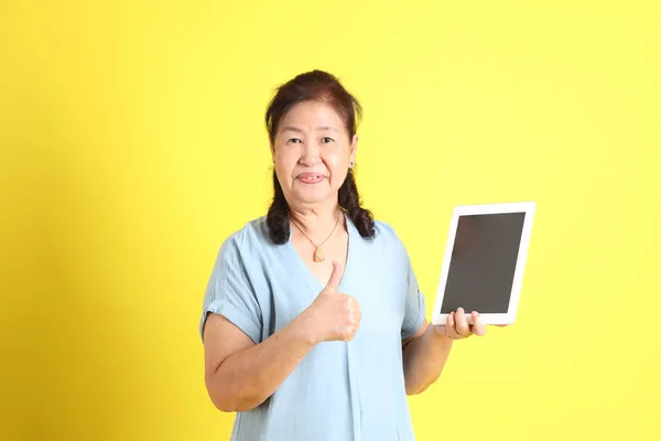 Asian Senior Woman Wearing Light Blue Shirt Standing Yellow Background — Foto de Stock