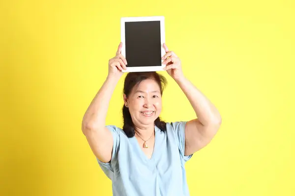 Asian Senior Woman Wearing Light Blue Shirt Standing Yellow Background — Foto de Stock