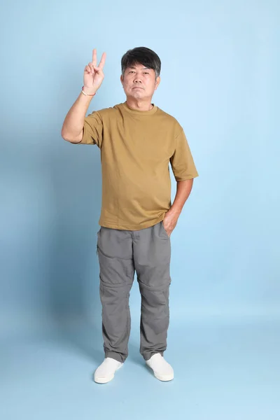 Senior Aziatische Man Met Casual Kleding Staan Blauwe Achtergrond — Stockfoto