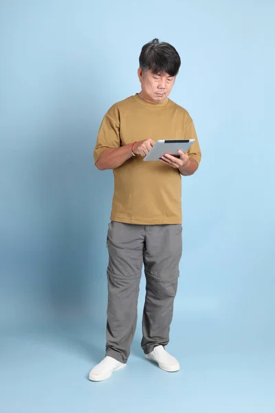 Ηλικιωμένος Ασιάτης Καθημερινά Ρούχα Που Στέκεται Στο Μπλε Φόντο — Φωτογραφία Αρχείου
