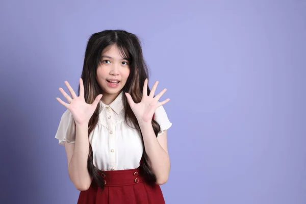 Милая Молодая Азиатка Красивой Одеждой Стоящая Фиолетовом Фоне — стоковое фото