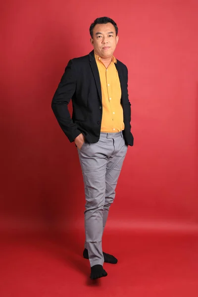 Asian Middle Aged Man Standing Red Background — Stockfoto