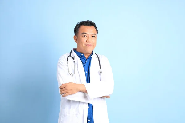 Kék Háttéren Álló Vezető Ázsiai Orvos — Stock Fotó