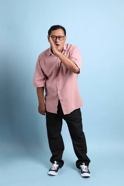 Adult Asian Man Pink Shirt Standing Blue Background — Stockfoto