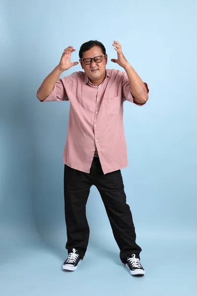 Adult Asian Man Pink Shirt Standing Blue Background — Stock Fotó