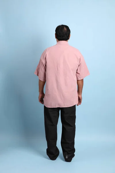 Adult Asian Man Pink Shirt Standing Blue Background —  Fotos de Stock