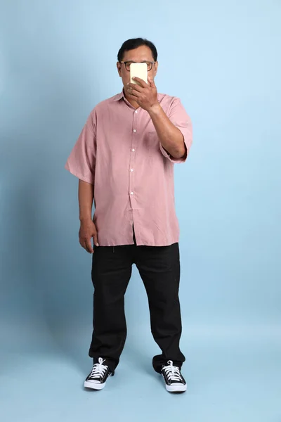 Adult Asian Man Pink Shirt Standing Blue Background — Stok fotoğraf