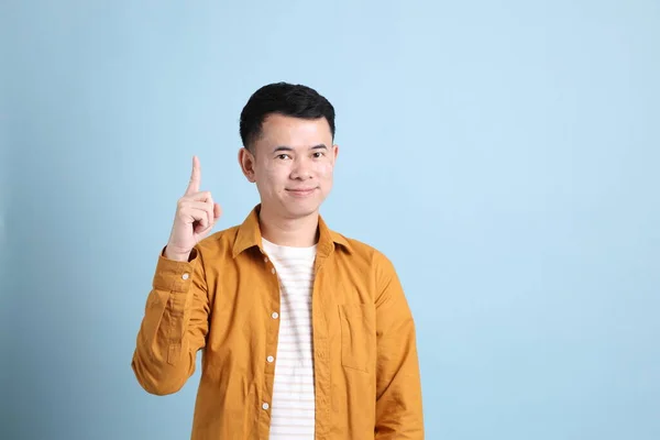 Asian Lgbtq Man Yellow Shirt Standing Blue Background — Stok fotoğraf