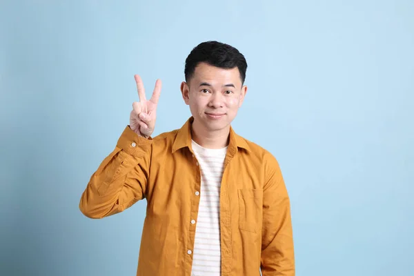 Asian Lgbtq Man Yellow Shirt Standing Blue Background — 스톡 사진