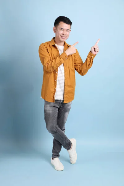 Asian Lgbtq Man Yellow Shirt Standing Blue Background — 스톡 사진