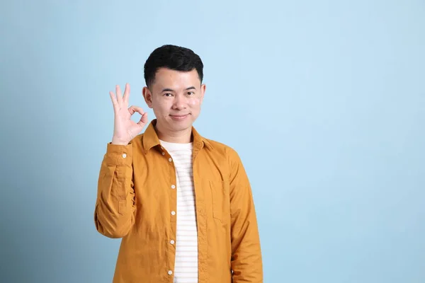 Asian Lgbtq Man Yellow Shirt Standing Blue Background — Stok fotoğraf