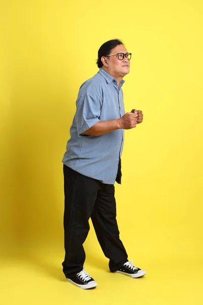 Adult Asian Man Blue Shirt Standing Yellow Background — Stock Fotó